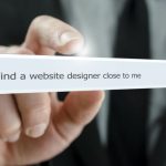 Photograph with a search field containing the search terms 'find a website designer close to me'