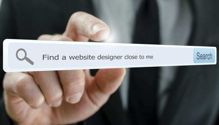 Photograph with a search field containing the search terms 'find a website designer close to me'